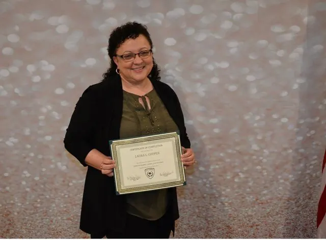 BCBC student holding a course completion certificate