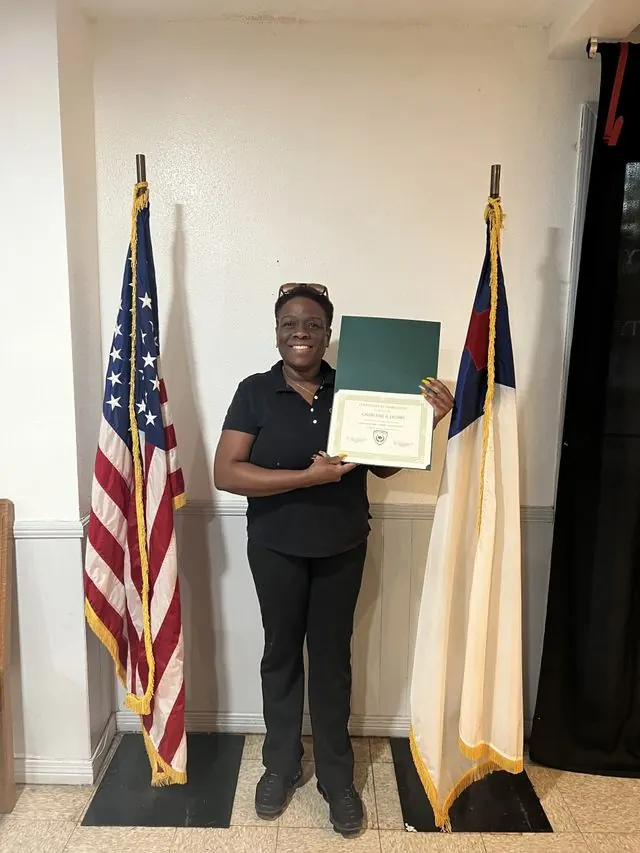 BCBC student holding a course completion certificate