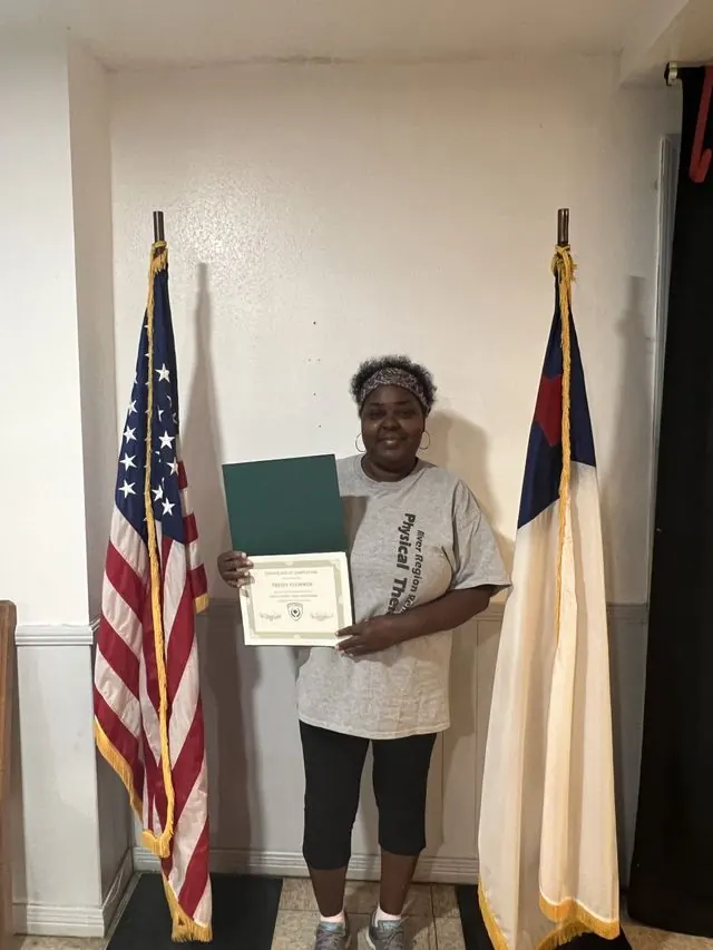 BCBC student holding a course completion certificate